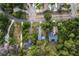 Aerial shot of multiple homes in a wooded neighborhood, showcasing the street layout and surrounding trees at 7470 Lake Marsha Dr, Orlando, FL 32819