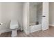 Well-lit bathroom featuring a toilet, tub and sleek modern fixtures with a neutral color palette at 7470 Lake Marsha Dr, Orlando, FL 32819