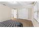 Neutral bedroom with wood floors, closet, window, and adjoining bathroom offers a clean and inviting space at 7470 Lake Marsha Dr, Orlando, FL 32819