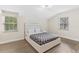 Bright bedroom features two windows and a modern platform bed, offers comfortable contemporary living at 7470 Lake Marsha Dr, Orlando, FL 32819