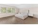 A bright bedroom with a large window and minimalist white decor at 7470 Lake Marsha Dr, Orlando, FL 32819