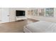 Bright bedroom with a large window, modern entertainment center and minimalist white decor at 7470 Lake Marsha Dr, Orlando, FL 32819