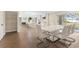 Elegant dining area with a modern table and chairs, flowing seamlessly into the kitchen and living spaces at 7470 Lake Marsha Dr, Orlando, FL 32819