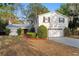 Charming two-story home featuring mature landscaping and a well-maintained front yard and a two-car garage at 7470 Lake Marsha Dr, Orlando, FL 32819