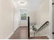 Bright hallway featuring wood floors, closet space and natural light from a window at 7470 Lake Marsha Dr, Orlando, FL 32819