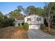 Well-maintained two-story home with a long driveway, manicured bushes, and a well kept lawn at 7470 Lake Marsha Dr, Orlando, FL 32819