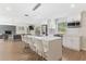 Bright kitchen with stainless steel appliances, subway tile backsplash, island seating, and an adjacent living area at 7470 Lake Marsha Dr, Orlando, FL 32819