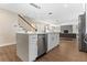Contemporary kitchen with a large island, stainless steel appliances, and an open layout connected to the living room at 7470 Lake Marsha Dr, Orlando, FL 32819