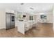 Modern kitchen featuring stainless steel appliances, a center island with bar seating, and wood-look flooring at 7470 Lake Marsha Dr, Orlando, FL 32819