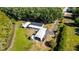 Aerial view showcasing home, sheds and garages on large lot at 8218 Pine Island Rd, Clermont, FL 34711
