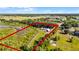 Expansive aerial view of the property highlighting the wooded lot and possible building locations at 8218 Pine Island Rd, Clermont, FL 34711