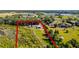 Aerial shot showing the expansive property surrounded by lush greenery and nearby lake at 8218 Pine Island Rd, Clermont, FL 34711