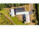 Aerial view of home on expansive lot featuring garages, sheds and mature landscaping at 8218 Pine Island Rd, Clermont, FL 34711