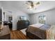 The bedroom features wood-look floors, a ceiling fan and a view from the window at 8218 Pine Island Rd, Clermont, FL 34711
