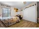 Comfortable bedroom with wood floors, closet, and natural light from the window at 8218 Pine Island Rd, Clermont, FL 34711