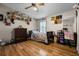 Inviting bedroom with wood floors, ceiling fan, and decorative shelving at 8218 Pine Island Rd, Clermont, FL 34711