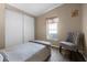 Cozy bedroom with neutral tones, wood floors, and a comfortable chair at 8218 Pine Island Rd, Clermont, FL 34711