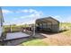 This outdoor carport offers convenient storage with its spacious design and added wood deck at 8218 Pine Island Rd, Clermont, FL 34711
