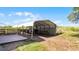 This outdoor carport offers convenient storage with its spacious design and added wood deck at 8218 Pine Island Rd, Clermont, FL 34711