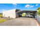 Large carport and storage building, offering ample parking and storage space, and a partially fenced yard at 8218 Pine Island Rd, Clermont, FL 34711