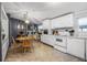 Bright kitchen featuring white cabinets, modern appliances, and a dining area for casual meals at 8218 Pine Island Rd, Clermont, FL 34711