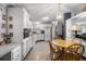 Spacious kitchen featuring white cabinets, appliances, and a dining area, offering functionality and style at 8218 Pine Island Rd, Clermont, FL 34711