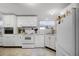 Functional kitchen with white appliances, ample countertop space, and natural light at 8218 Pine Island Rd, Clermont, FL 34711