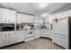 Well-lit kitchen with white cabinetry, appliances, and functional layout at 8218 Pine Island Rd, Clermont, FL 34711