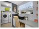 The laundry room connects to the office with a washer, dryer and storage at 8218 Pine Island Rd, Clermont, FL 34711