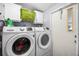 This laundry room features a washer, dryer and storage space at 8218 Pine Island Rd, Clermont, FL 34711