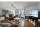 Inviting living room with wood floors and a comfortable seating arrangement, perfect for Gathering and guests at 8218 Pine Island Rd, Clermont, FL 34711