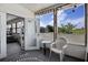 Inviting outdoor patio area with view of the yard and a comfortable chair for relaxing and enjoying nature at 8218 Pine Island Rd, Clermont, FL 34711