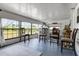 A screened porch with comfortable seating offers a relaxing outdoor space at 8218 Pine Island Rd, Clermont, FL 34711