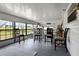 The screened porch has seating, views, and a peaceful atmosphere at 8218 Pine Island Rd, Clermont, FL 34711