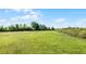 Sprawling grassy yard offers ample space for outdoor activities and potential landscaping at 8218 Pine Island Rd, Clermont, FL 34711