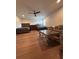 Spacious bedroom with hardwood floors, ceiling fan, and comfortable furniture arrangement at 8405 Adalina Pl, Orlando, FL 32827