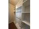 Bright walk-in closet with custom built-in shelving and chrome hanging rods at 8405 Adalina Pl, Orlando, FL 32827