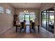 Dining room with tile floors, decorative light fixture, and a view of the outside lake at 8405 Adalina Pl, Orlando, FL 32827