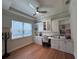 This home office features custom built-in cabinets, and shelving with great light from an adjacent window at 8405 Adalina Pl, Orlando, FL 32827