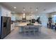 A beautifully appointed kitchen features white cabinets, stainless appliances, and a large central island at 8405 Adalina Pl, Orlando, FL 32827