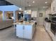 Spacious kitchen with central island, stainless appliances, and white cabinets, perfect for entertaining at 8405 Adalina Pl, Orlando, FL 32827