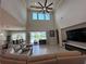 This living room features high ceilings, modern fireplace, tile floors and views of the outdoor area at 8405 Adalina Pl, Orlando, FL 32827