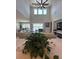 The living room features high ceilings, tile flooring, and a view of the back porch and lake at 8405 Adalina Pl, Orlando, FL 32827