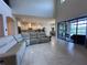 This living room is open to the kitchen, features tile floors and an amazing view of the outdoor living area at 8405 Adalina Pl, Orlando, FL 32827