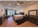 Serene bedroom retreat with hardwood floors, ample natural light, and a cozy sitting area perfect for relaxation at 8405 Adalina Pl, Orlando, FL 32827