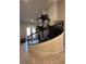 The curved staircase is a focal point with wrought iron railings and natural light from the double doors at 8405 Adalina Pl, Orlando, FL 32827