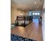 Upstairs hallway with wood floors, black iron railing, and a view of the living space below at 8405 Adalina Pl, Orlando, FL 32827