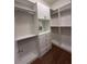 A bright walk-in closet features adjustable shelving, drawers and cabinets for maximum storage and organization at 8405 Adalina Pl, Orlando, FL 32827