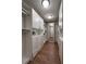 Well-organized walk-in closet with custom shelving and drawers, providing ample storage space and a mirror at 8405 Adalina Pl, Orlando, FL 32827
