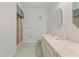 Bright bathroom featuring a glass-enclosed shower and large mirror at 8830 Sw 98Th Pl # M, Ocala, FL 34481
